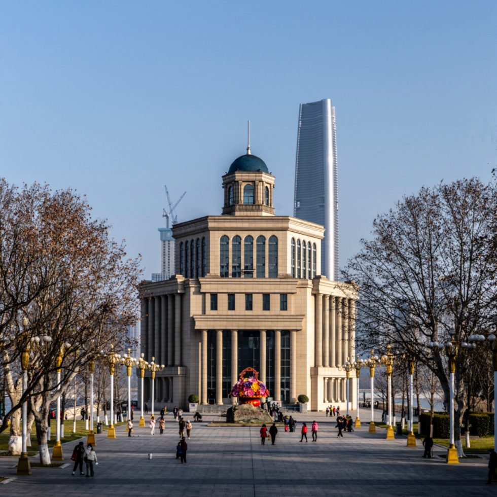 This is a color photograph of a city plaza with a stoic monument type structure.